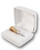 Metal double ring box with white leatherette exterior and interior with white satin puff.