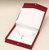 Red paper necklace gift box with white interior pad and veil cover. Also includes a snap button close.
