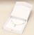 White paper necklace gift box with white interior pad and veil cover. Also includes a snap button close.