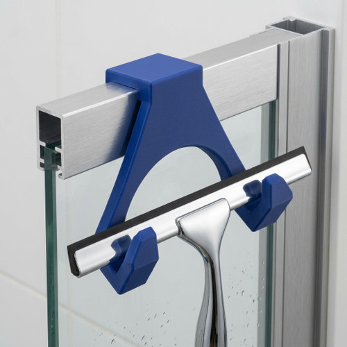 Blue 3D printed shower squeegee holder mounted on a frameless shower screen, securely holding a stainless steel window squeegee for convenient bathroom storage.