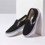 Vans Kids' Classic Slip On Shoes in black viewed from angled side perspective