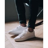 Clae Men's Bradley shoes in triple white, angled lifestyle view