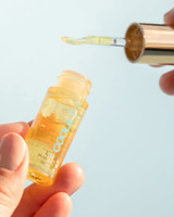 COOLA Liplux Hydrating Lip Oil bottle detail