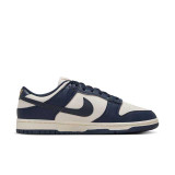 Nike Women's Dunk Low Retro Shoes in Navy and Sail White, side view
