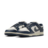 Nike Women's Dunk Low Retro Shoes in Navy and Sail White, angle view