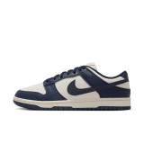 The Nike Women's Dunk Low Retro Shoes in Navy and Sail White