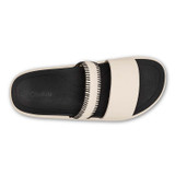 The Olukai Women's Pae Leather Slide Sandals in White Sand/Lava Rock