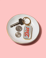 Brittany Paige Diet Soda Can Enamel Keychain on dish detail