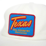The Texas Hill Country Provisions TX Retro Trucker Hat in Vintage White