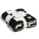 Checkered Reversible Throw Blanket in Black and White draped