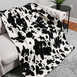 Cow Print Throw Blanket in Black and White draped angle