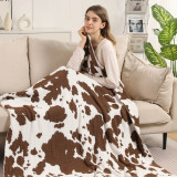 Cow Print Throw Blanket in Brown and White flat lay