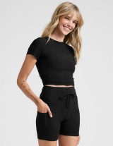Beyond Yoga Women's Featherweight Cropped Tee in darkest night, side view.