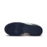 The Nike Women's Dunk Low Retro Shoes in Navy and Sail White