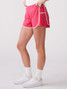 Thrive Societe Women's Pleated Side Run Short in Solar Pink back view
