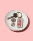 Brittany Paige Diet Soda Can Enamel Keychain on dish detail