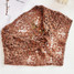 Crochet Bandana Shawl in mocha, displayed flat from front angle view.