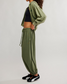 FP Movement Women's Momentum Pants in ivy green, side view