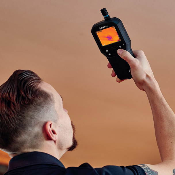 FLIR MR277 Professional Moisture Meter in hand above head
