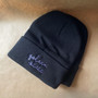 "Golden State" embroidered in cursive in lavender onto a black beanie