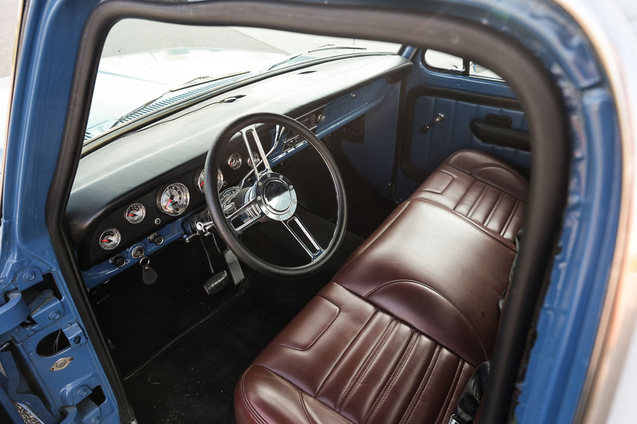 The interior of QA1’s 1972 Ford F100 “New Blue” features a TMI seat and a full array of Auto Meter gauges, providing comfort and modern functionality for daily driving.