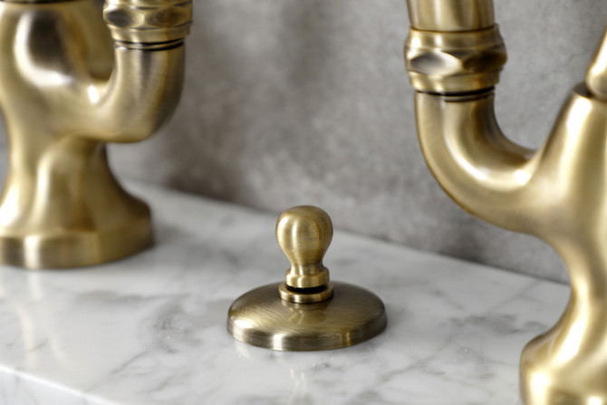 Kingston Brass KS7993TAL Tudor Bridge Bathroom Faucet with Brass Pop-Up, Antique Brass