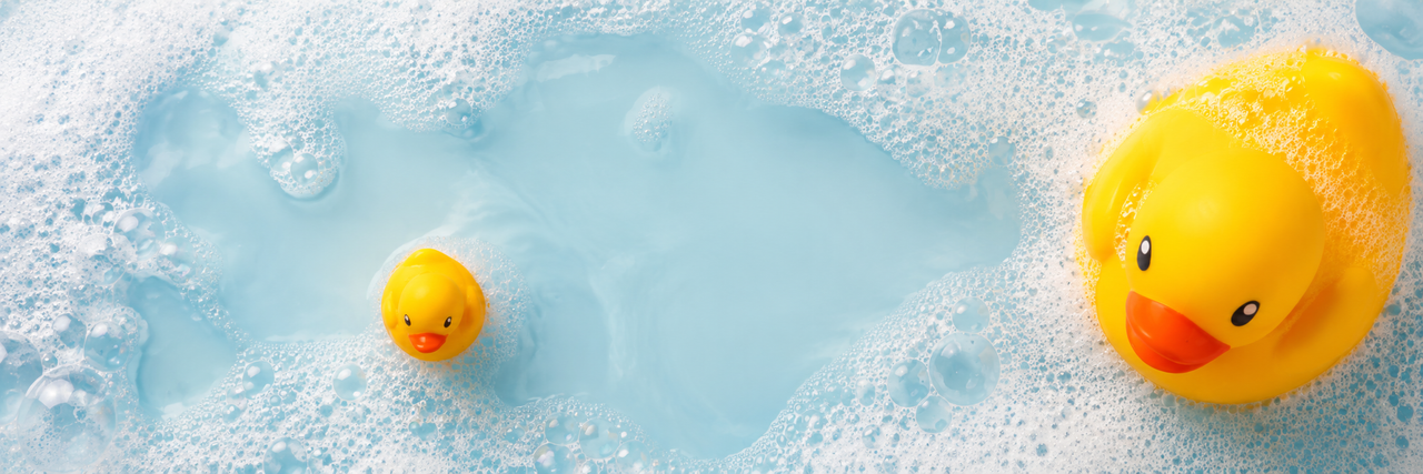 Rubber ducks floating in a bubbly bath