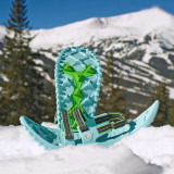 Luna snowshoes with foam deck and ice spikes in snow-covered landscape Luna snowshoes with foam deck and ice spikes in snow-covered landscape