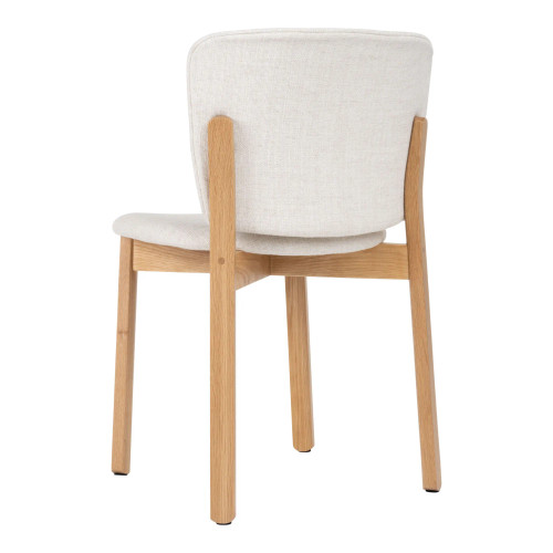 Back angle view of Pinta Side Chair highlighting shapely upholstery and supportive timber cross-leg base.