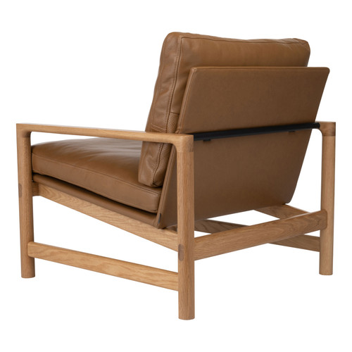 Back angle view of the Troubadour Lounge Chair with mid-century design, oak frame, and leather upholstery.