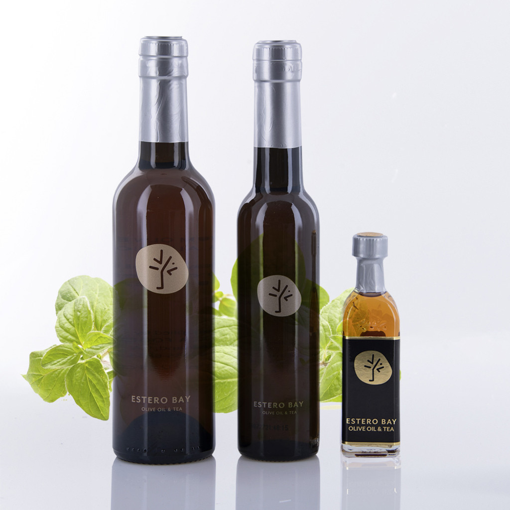 Three different size bottles of Estero Bay Olive Oil & Tea Oregano White Balsamic Vinegar.