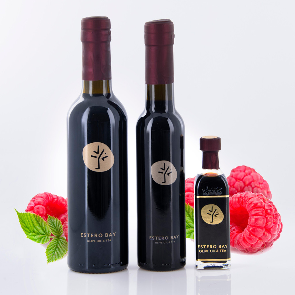 Three different size bottles of Estero Bay Olive Oil & Tea Raspberry Dark Balsamic Vinegar.