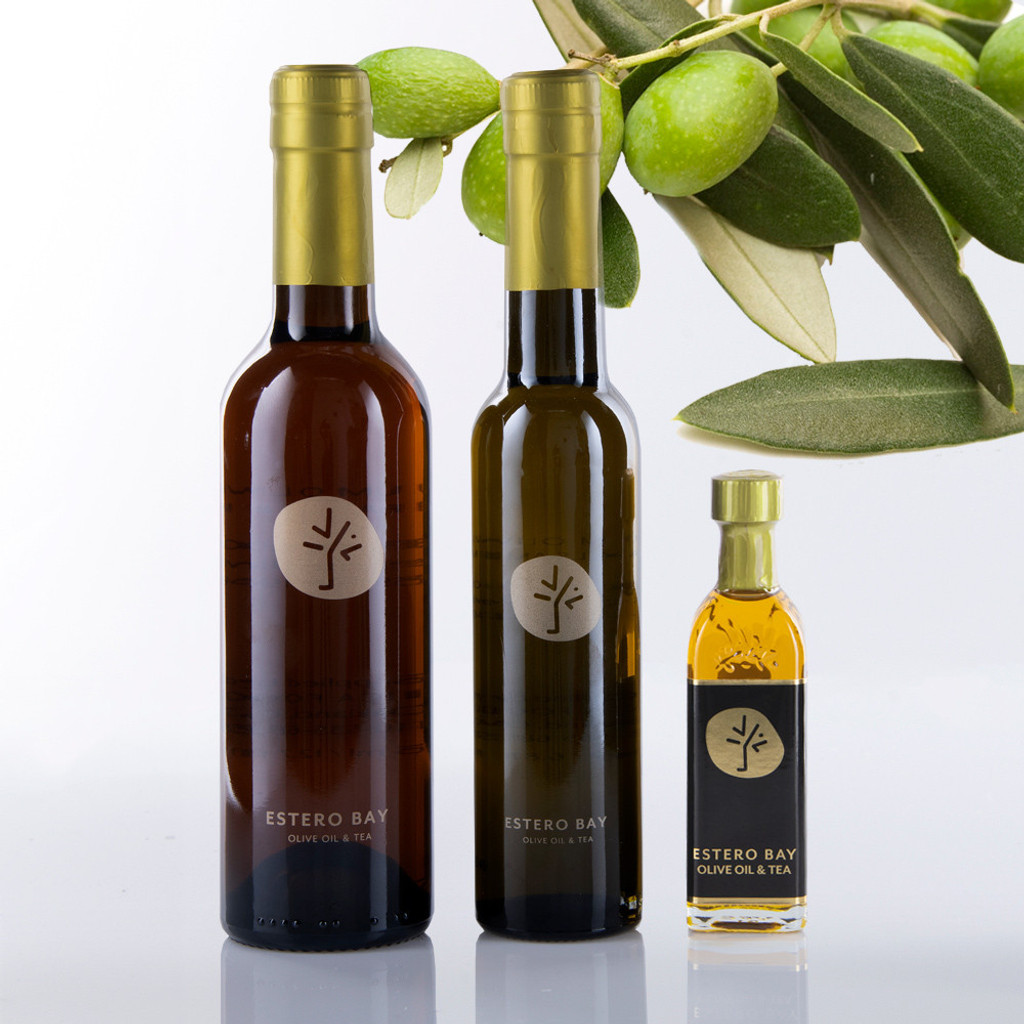 This photo contains 3 bottles of Estero Bay Olive Oil and Tea Company extra virgin olive oil with an olive branch