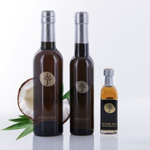 Three different size bottles of Estero Bay Olive Oil & Tea Coconut White Balsamic Vinegar.