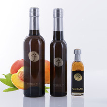 Three different size bottles of Estero Bay Olive Oil & Tea Ripe Peach White Balsamic Vinegar.