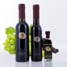 Three different size bottles of Estero Bay Olive Oil & Tea SABA Dark Balsamic Vinegar.