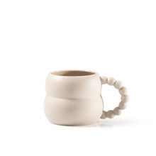 a Blue and an off-white mug with whimsical beadlike handles