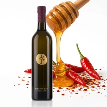 Estero Bay Hot Honey Vinegar Condimento 750ml bottle with honey dipper and Calabrian chili peppers