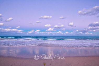 A purple sunset at the beach of Boca Raton, Florida looking out to the Atlantic Ocean. Landscape photograph by Shelley Coar.