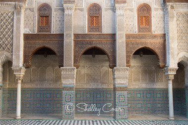 A photograph of a white and blue tiled Moroccan riad or garden courtyard in Fez, Morocco  by Shelley Coar.