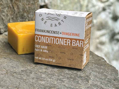 One Earth Body Care Conditioner Bar for Oily Hair, Frankincense-Tangerine aroma. Naked square conditioner bar next to compostable box package. One Earth Body Care Conditioner Bar for Oily Hair, Frankincense-Tangerine aroma. Naked square conditioner bar next to compostable box package.