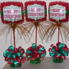 Green candy bouquet holders used as bases for Christmas balloon arrangements.