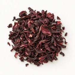 Image - Loose dried hibiscus flowers on a warm-white background.