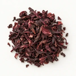 Image - Loose dried hibiscus flowers on a warm-white background.