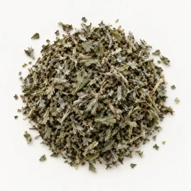 Image - Loose dried mugwort on a warm-white background.