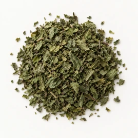 Image - Loose dried spearmint leaf on a warm-white background.