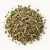 Loose dried blessed thistle on a warm-white background.