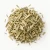 Loose dried lemongrass on a warm-white background.