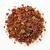 Loose dried rose hips on a warm-white background.