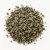 Loose dried mugwort on a warm-white background.